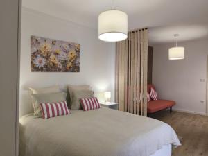 a bedroom with a large bed with two pillows at Flor de Charme in Campo Maior