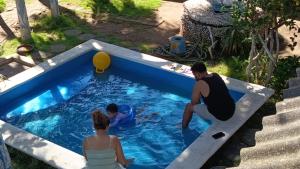 a group of people playing in a swimming pool at Hotel Restaurante Spa La Barca de Oro in Las Peñitas