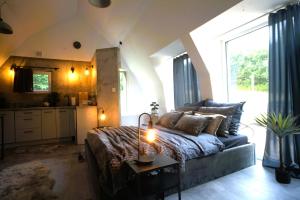 a living room with a couch and a table at Bunkier House in Niedźwiada