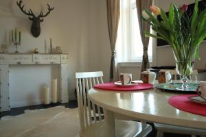 a dining room table with a vase of flowers on it at Alt Wien in Vienna