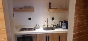 a small kitchen with a sink and a stove at كوخ ساره سبيشل دورين in Al-ʿUla +29 photos