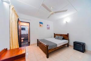 a bedroom with a bed and a ceiling fan at Cloud Inn Kandy Homestay - Near temple tooth in Kandy