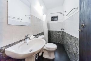 a white bathroom with a sink and a toilet at Cloud Inn Kandy Homestay - Near temple tooth in Kandy