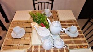 a table with a tea set on top of it at Cloud Inn Kandy Homestay - Near temple tooth in Kandy