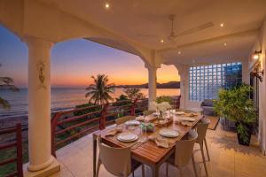 a dining room with a table and a view of the ocean at Beachfront Penthouse with Panoramic Ocean Views in Playa Flamingo
