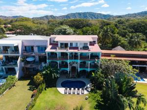 an aerial view of a large house with a yard at Beachfront Penthouse with Panoramic Ocean Views in Playa Flamingo