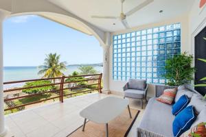 a living room with a couch and a view of the ocean at Beachfront Penthouse with Panoramic Ocean Views in Playa Flamingo +17 photos