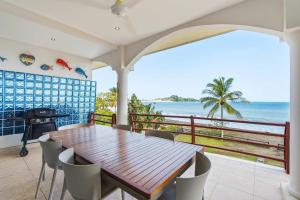 a dining room with a table and a view of the ocean at Beachfront Penthouse with Panoramic Ocean Views in Playa Flamingo