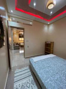 a bedroom with a large bed and a mirror at Quiet Aourire Hideway in Aourir
