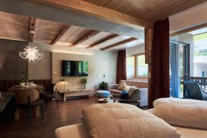 a bedroom with a bed and a living room at Apart Marienberg in Lermoos