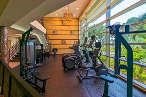 a gym with a row of treadmills and ellipticals at Dolphin & Manatee Cove Condo: Beach Access + More! in Gulf City