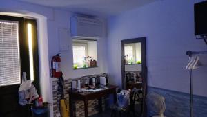 a blue room with a table and two mirrors at enrica barrani room in Vernazza