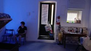 a woman sitting in a chair in a room with a window at enrica barrani room in Vernazza