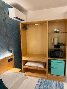 a bedroom with a bed and a book shelf at Relax nel Centro Storico in San Nicola Arcella