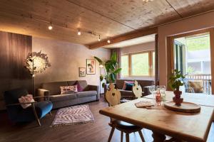 a living room with a table and a couch at Apart Marienberg in Lermoos