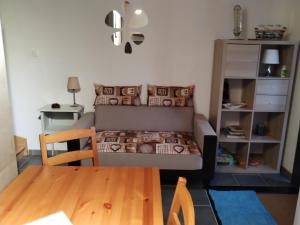 a small bedroom with a bed and a table at Le Cigalou - Drôme Provencale in Sainte-Jalle