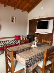 a room with a bed and a table and a tv at Complejo Punto Medio in Santa Rosa