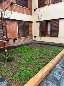 a building with two trees in front of it at Complejo Punto Medio in Santa Rosa