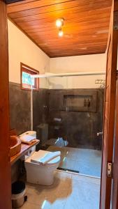 a bathroom with a toilet and a sink at Bossa Atins in Atins +30 photos