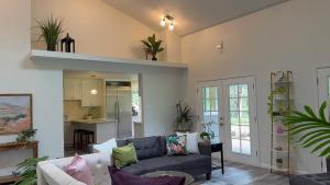 a living room with a couch and a kitchen at Hale Kululoa in Hilo