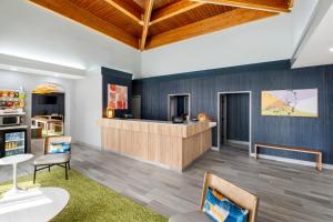 a waiting room with a counter and chairs at Spark By Hilton Staunton in Staunton