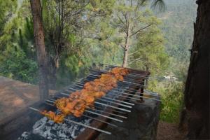 a pile of food on top of a grill at Brookside Pines in Murree