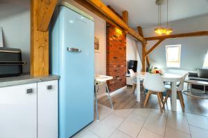 a kitchen with a refrigerator and a dining room at Apartamenty Centrum - Moonlight in Opole +20 photos