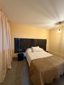 a bedroom with a bed and a large window at Loft Don Bosco in San Luis