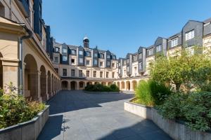a large building with a pathway in front of it at Duplex de charme dans un Cloître historique Parking privé in Rouen