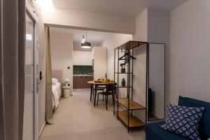 a living room with a blue couch and a table at Annasa Suites 2 in Mángana