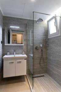 a bathroom with a shower and a sink at Annasa Suites 2 in Mángana +29 photos