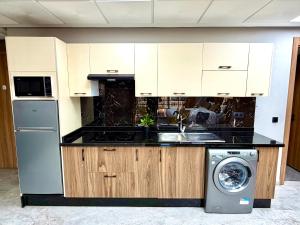 a kitchen with a sink and a washing machine at Studio plein centre-ville ! in Fez +8 photos