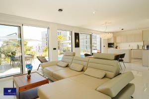 a living room with a couch and a kitchen at Primosten Hills West - Branded Luxury Villa in Primošten