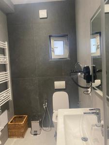 a bathroom with a sink and a toilet and a window at Arvi Boutique Hotel in Lukovë +34 photos