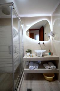 a bathroom with a sink and a mirror at Rousis Studios in Parga +40 photos