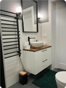 a bathroom with a sink and a mirror at Wypoczynek nad morzem Uzdrowiskowa 115 in Przewłoka +12 photos