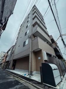 a tall building with a television in front of it at NUPRIME morishita in Tokyo