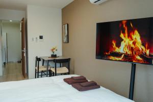 a bedroom with a bed with a fire on the wall at NUPRIME morishita in Tokyo