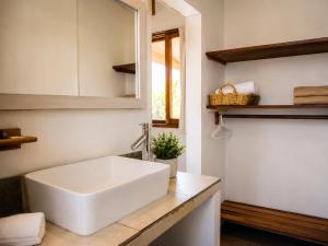 a bathroom with a white sink and a mirror at Meson de Valle Hotel in Valle de Bravo