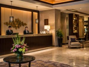 a lobby with two people at a reception desk at Hotel Platinum Square in New Delhi