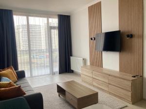 a living room with a couch and a tv at AL Mаre in Batumi