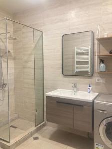 a bathroom with a sink and a glass shower at AL Mаre in Batumi +11 photos