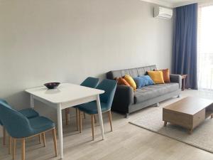 a living room with a couch and a table and chairs at AL Mаre in Batumi