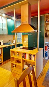 a kitchen with a yellow island with a stove at Marilyn Apartments in Smederevo