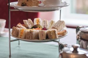 a three tiered plate of sandwiches and bread at Cober Hill in Scarborough