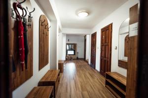 a hallway with wooden floors and wooden benches at Chata u Mikiho Krahule in Krahule +22 photos