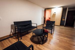 three black chairs and a table in a room at Chata u Mikiho Krahule in Krahule