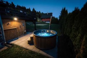 a large hot tub sitting on a patio at Chata u Mikiho Krahule in Krahule
