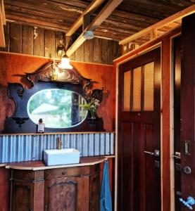 a bathroom with a sink and a mirror at Eco glamping tent 'Basilikus' in Laakdal