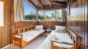 two beds in a room with two windows at Casa fig Crete in Chania